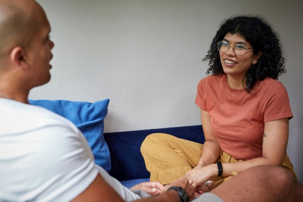 a man and a woman sitting and talking