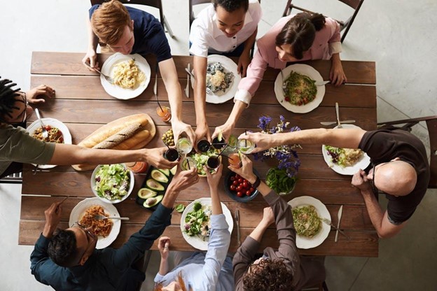 people sitting at a table for a holiday meal