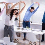 a man and a woman stretching at a desk