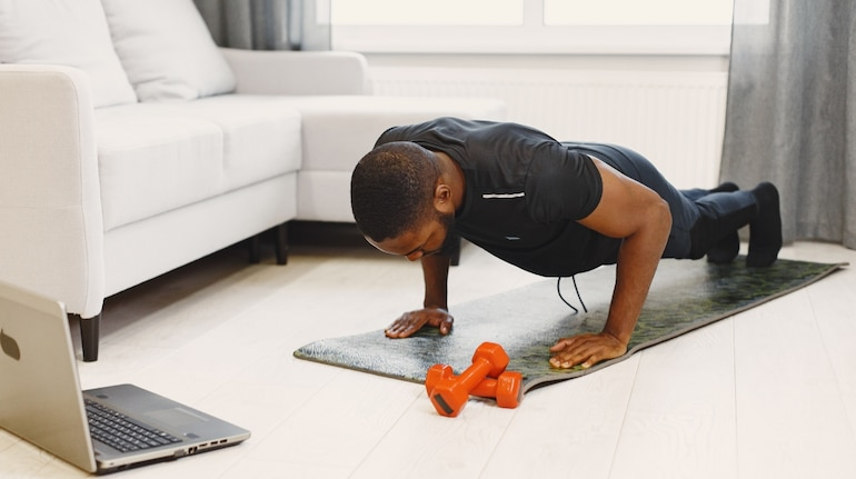 a man doing a plank while watching tv