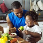 A man and child at a counter with food