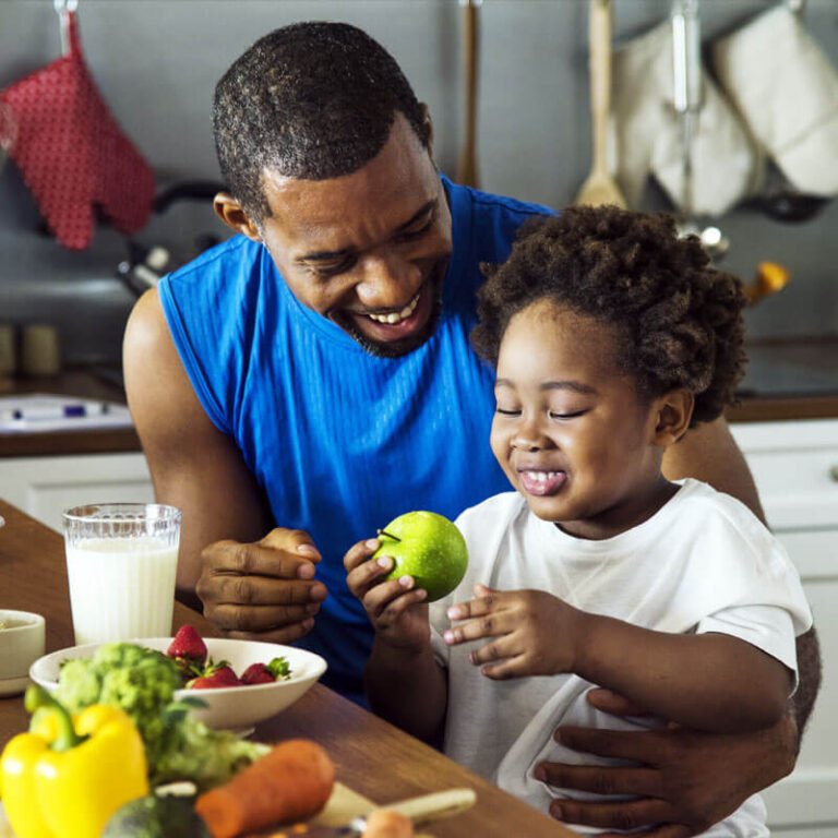 A man and child at a counter with food