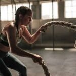 A woman using battle ropes.