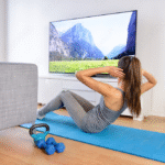 A woman exercising in front of a TV