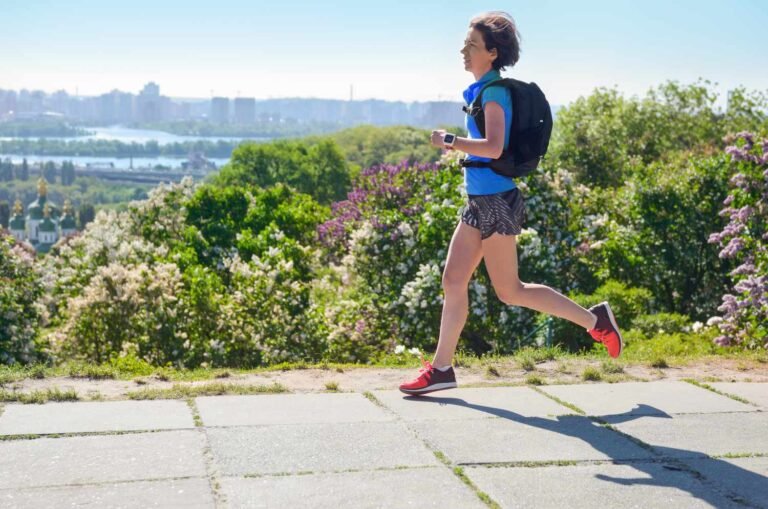 A woman jogging with a backpack