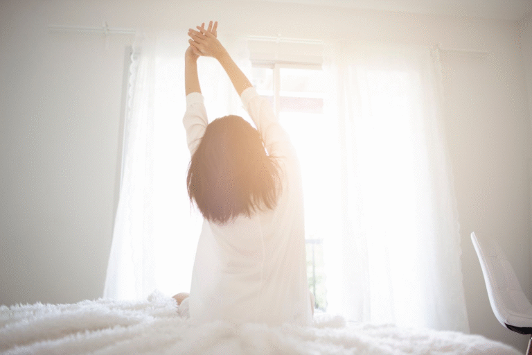 A woman waking up and stretching