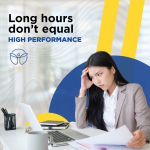 A woman who looks stressed sitting at a desk.