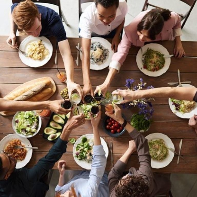 people sitting at a table for a holiday meal