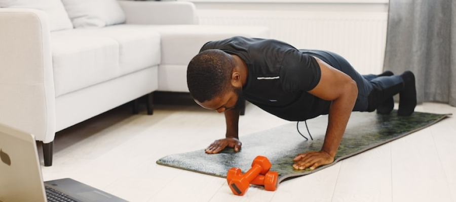 a man doing a plank while watching tv