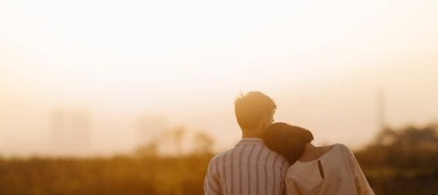 A man and a woman standing and hugging