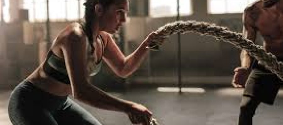 A woman using battle ropes.