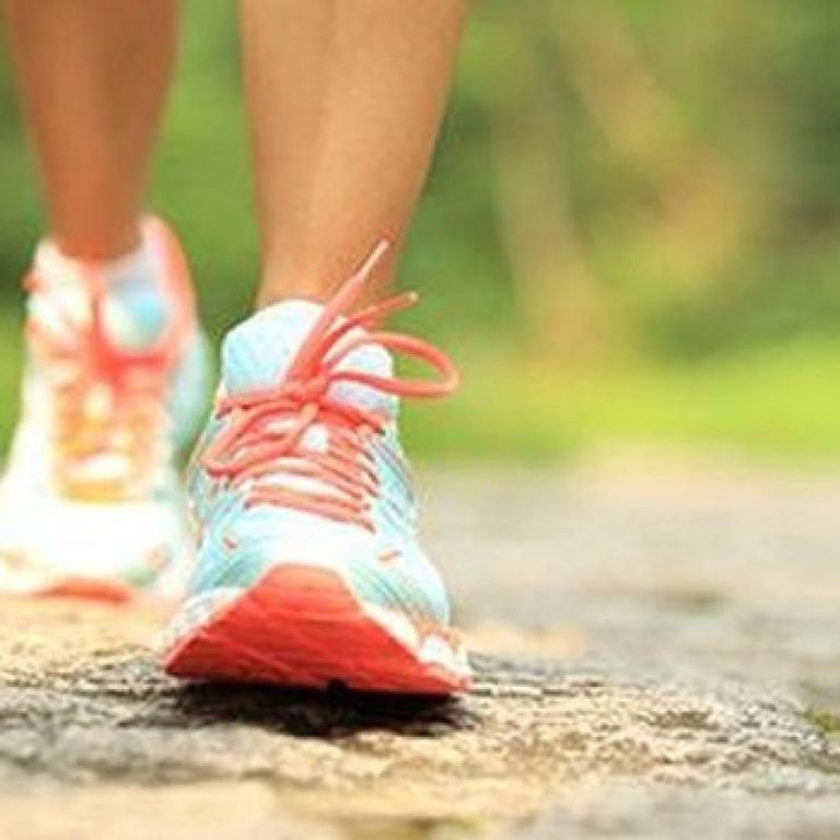 The feet of a person walking.