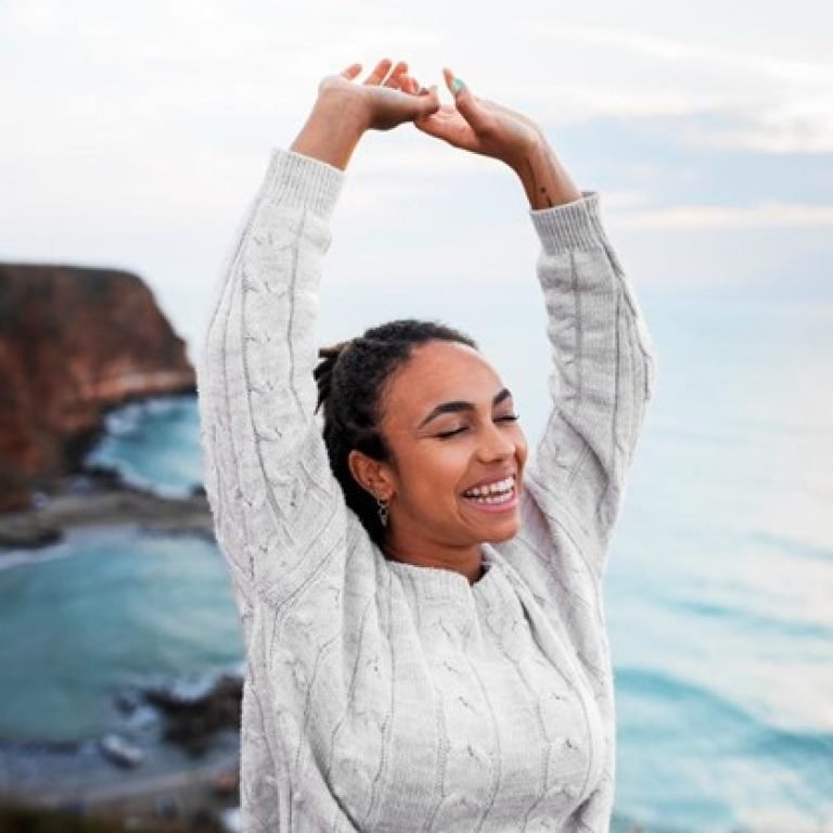 A lady reaching above her head