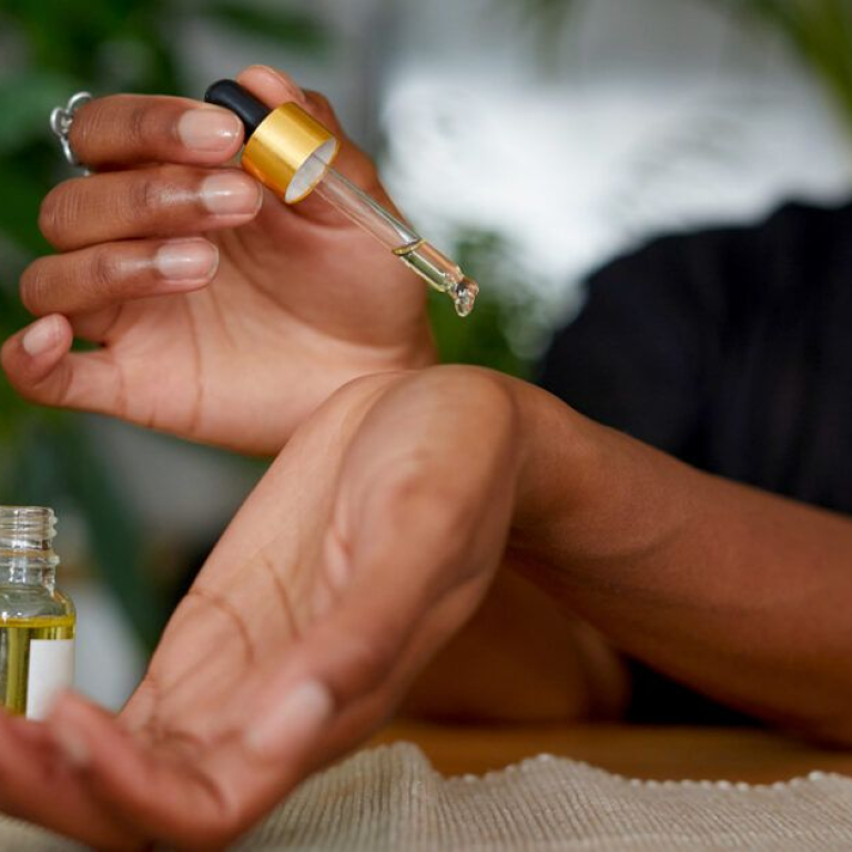 A woman put drops on her wrist