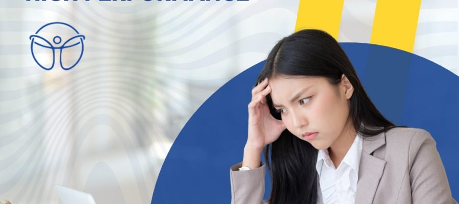 A woman who looks stressed sitting at a desk.