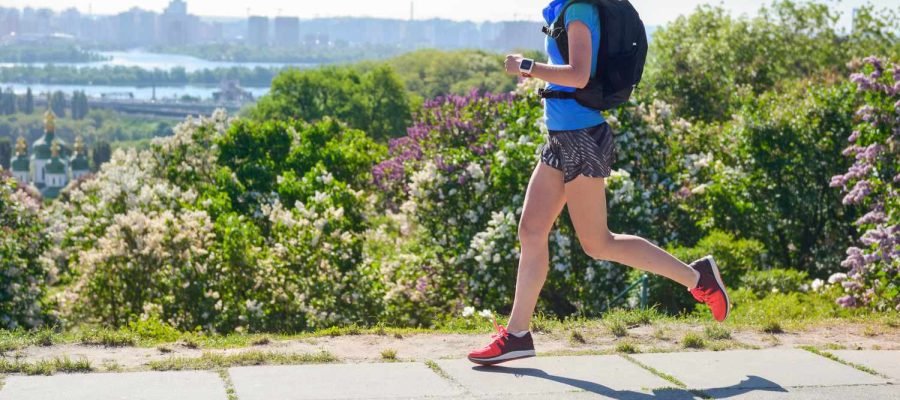 A woman jogging with a backpack